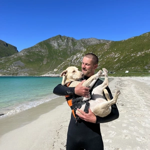 harry holding sandy on the beach in norway